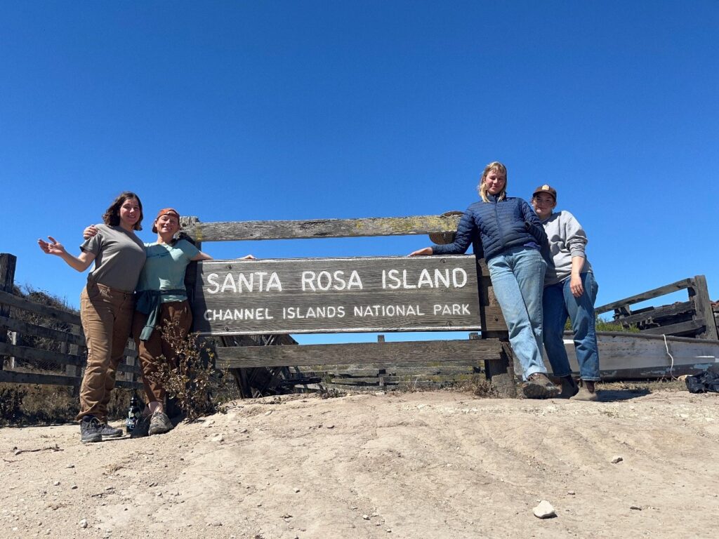 Team photo in front of sign on Santa Rose Island in Channel Island National Park