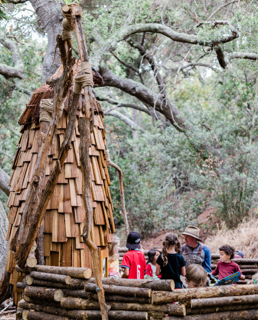 Kids reading in Hawks Nest Casitas as Santa Barbara Botanic Garden