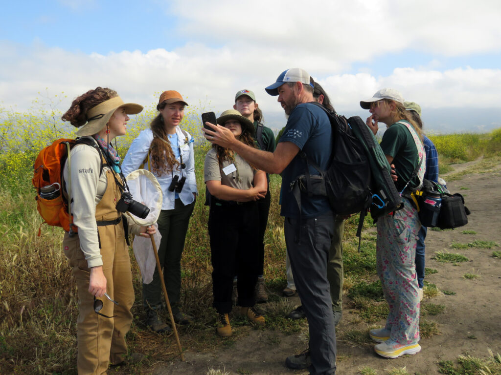 Biologist talking to a group of citizens about native plants