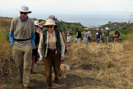 Couple leading trail walk overlooking ocean in Elings Park Santa Barbara, California