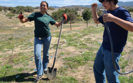 Two Garden interns dancing as they work on a conservation project