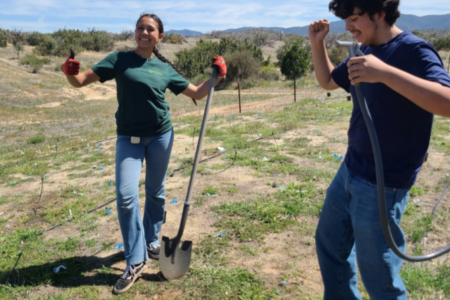 Two Garden interns dancing as they work on a conservation project